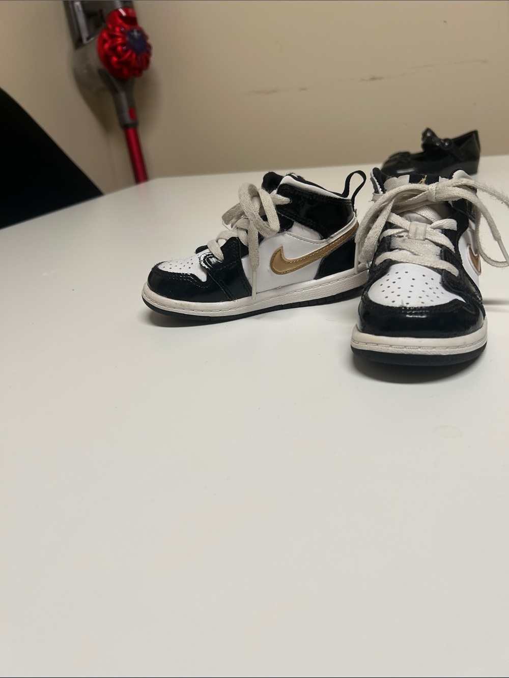 Air Jordan’s classic toddler ' Black & White High-Top Sneakers with Gold Swoosh